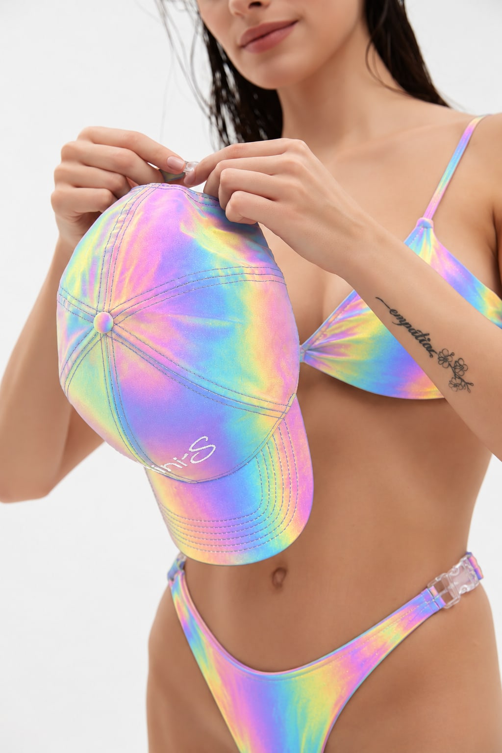 CLICK cap on a model, reflective iridescent fabric under flash