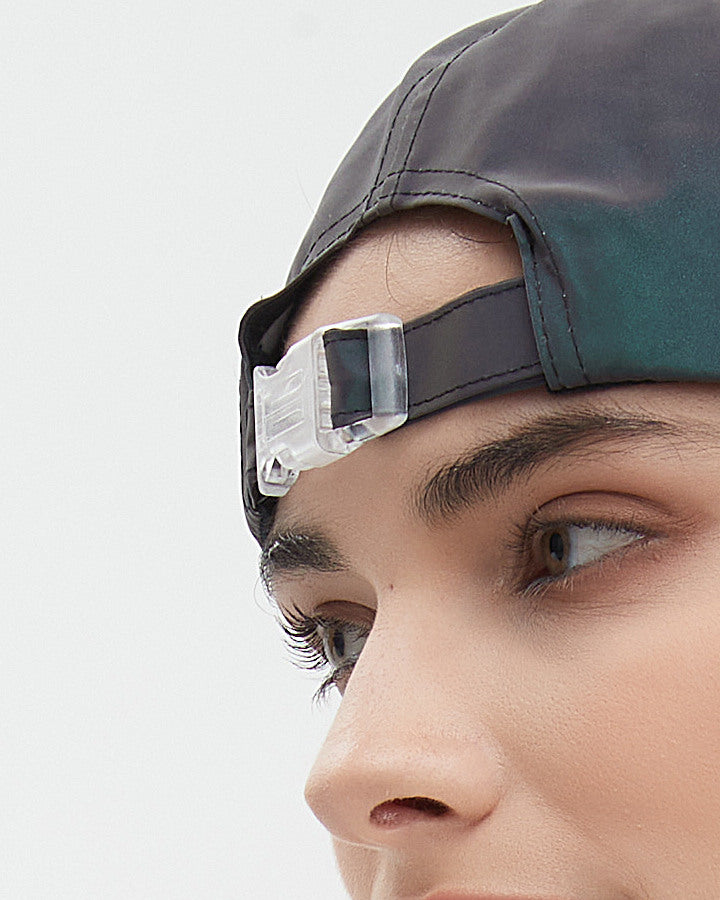 Detail of the CLICK cap closure, shown with the cap worn backwards